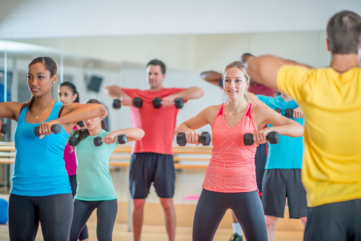 Group of people lifting dumbbells in a fitness class