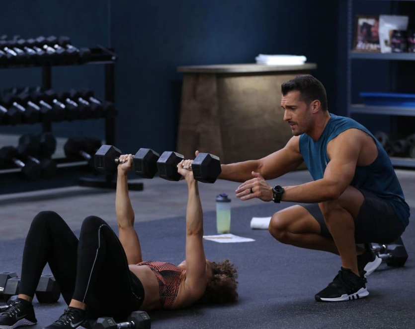 Three women in workout gear high-fiving